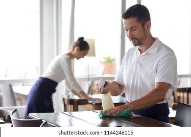 Close Up Of Worker In Restaurant Cleaning