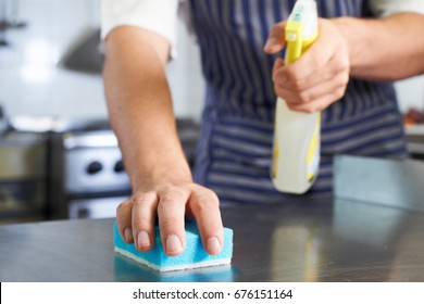 Close Up Of Worker In Restaurant Kitchen Cleaning Down After Service - Shutterstock ID 676151164