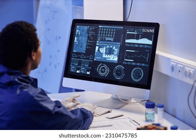 Close up of worker using computer with scientific data while doing research in laboratory, copy space