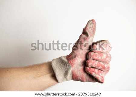 close up of workman hand in weared protective glove showing like gesture; left hand