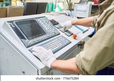 Close up of  workman  operating machines in industrial shop standing by electronic control panel and pushing buttons, copy space - Shutterstock ID 776675284