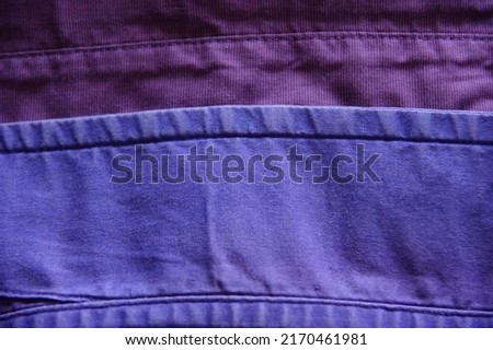 Close up of worn fabric on two shirt collars. Favorite outworn clothes concept