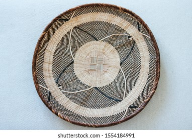 Close Up Of A Woven African Art Basket Isolated On White Background.