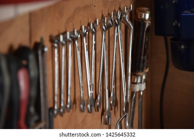 Close up of wrenches hanging.