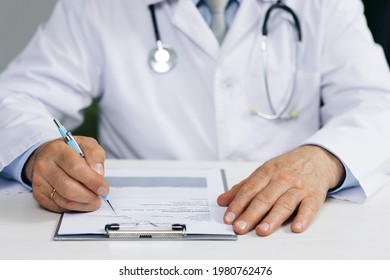 Close Up Wrinkled Male Doctor Writing Information In Medical Registration Journal. Confident Old Mature Male Doctor Physician Therapist Working At Office, Handwriting Notes