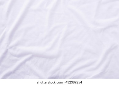 Close Up Of Wrinkled White Bedsheet Texture Background.
