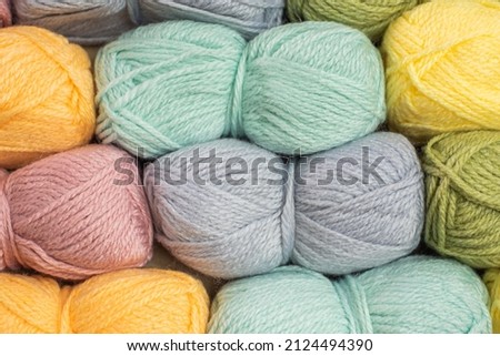 Close Up of yarn balls. Rainbow colors. Yarn for knitting. Skeins of yarn. Knitting needles, colorful threads. Knitting background, Knitting yarn for handmade winter clothes. top view table concept.