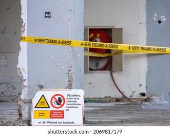 Close up of yellow barrier tape and sign. Warning and symbol: no access, forbidden entry. Toxic substances, hazardous. White asbestos on construction site. Demolition building. Asbest, serie. 
