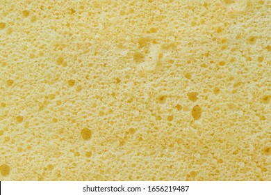 Close up yellow homemade airy sponge cake flavored with vanilla texture for background.