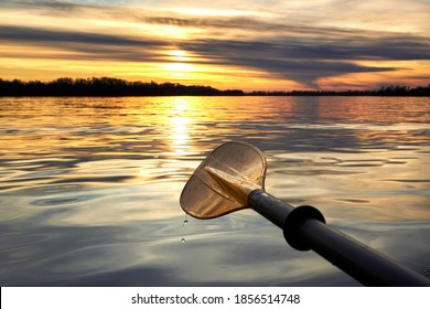 Close up of yellow kayak paddle (oar) at autumn sunset over Danube river - Powered by Shutterstock