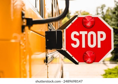 Close up yellow school bus. Stop sign. Be careful, schoolchildren crossing the road. New academic year semester. Welcome back to school. Lockdown, distance remote education learning - Powered by Shutterstock