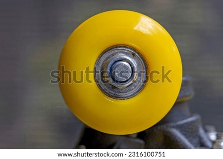 Close up of a yellow skateboard wheel