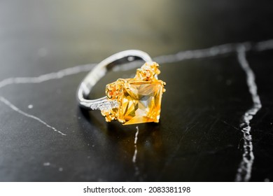 Close Up Of Yellow Topaz Ring On Black Marble