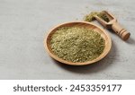 close up yerba mate tea leaves in wood bowl and scoop on white table food copy space background