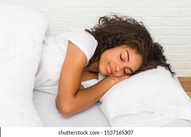 Close Up Of A Young African American Tired Woman Sleeping On The Bed