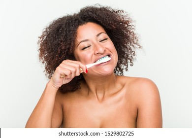 Close Up Of A Young African American Woman Brushing Her Teeth With A Toothbrush