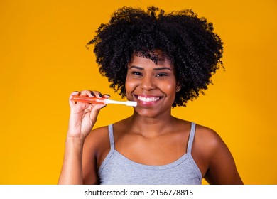 Close Up Of A Young African American Woman Brushing Her Teeth With A Toothbrush