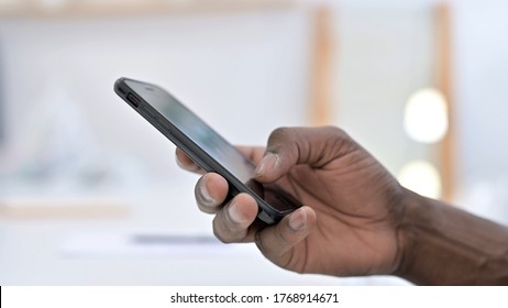 Close up Young African Man Hand Scrolling on Phone