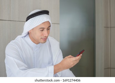 Close Up Of Young Arab Middle Eastern Businessman Using Mobile Smartphone In Office