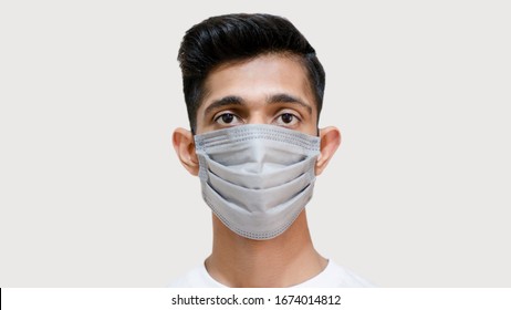 Close Up Of Young Asian Boy Wearing Mask Against The Corona Virus Covid 19 Brown Man Wearing Surgical Mask To Prevent From Virus White Background Face Close Up Young Doctor Face Closeup