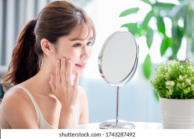 Close Up Of Young Asian Has Good Skin Care And She Look In Mirror