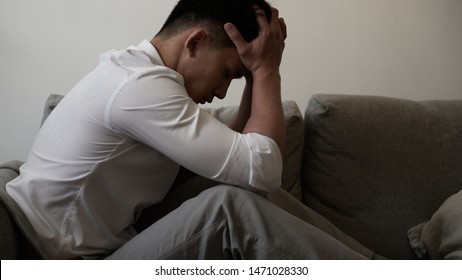 Close up young Asian man feeling upset, sad, unhappy or disappoint crying lonely in his room.