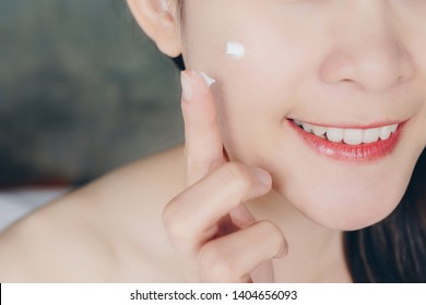 Close Up Of Young Asian Woman Applying Acne Cream Or Moisturizer On Her Face. Conceptual Of Beauty And Cosmetic.