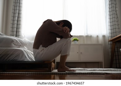 Close up young Asian woman feeling upset, sad, unhappy or disappoint crying lonely in her room. Woman health mental problem concept. - Shutterstock ID 1967434657