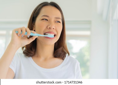 Close Up Young Beautiful Asian Woman Using Toothbrush To Brushing Teeth At Bathroom In The Morning Fro Healthy And Routine Life Concept