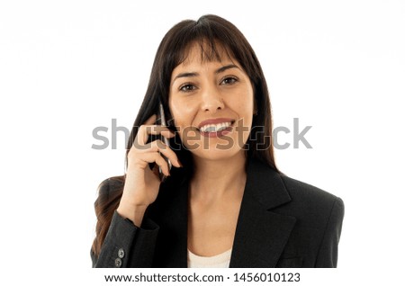Close up of a young beautiful business woman standing speaking on the phone holding a folder. Smiling feeling confident and successful. In people business education, communication and work concept.