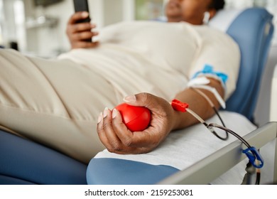 Close Up Of Young Black Woman Squeezing Stress Ball While Giving Blood At Donation Center, Copy Space