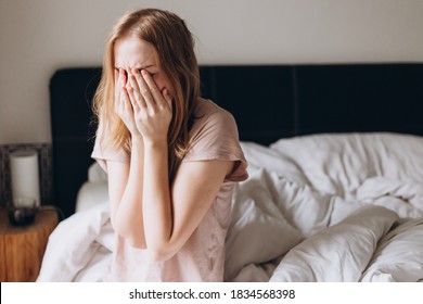 Close up young blonde woman feeling upset, sad, unhappy or disappoint crying lonely in bedroom. Emotional shock and life problems