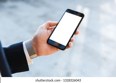 Close Up Of A Young Business Man Wearing Suit Looking At Blank Screen Mobile Phone Outdoors