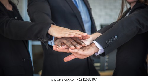 business people joining hands held high