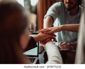 Close Up Of Young Business People Putting Their Hands Together. Stack Of Hands. Unity And Teamwork Concept..