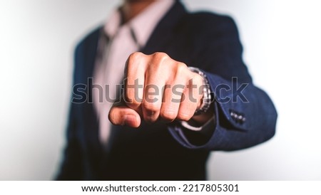 Close up of young businessman fist bump on white background. Business people wear suit do a fist pump together after good deal. Business success and teamwork concept.