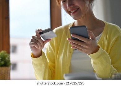 Close Up Of Young Businesswoman Entering Typing Credit Card Number On Smartphone, Feeling Excited To Purchase Items From An Online Store, Order Food, Pay Bills.