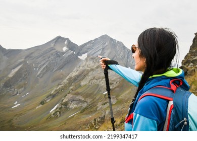 Close Up Young Caucasian Woman Hiker Stand On Viewpoint Show Destination Mountains Point Finger Left Outdoors Destination. Guide Young Woman In Mountains