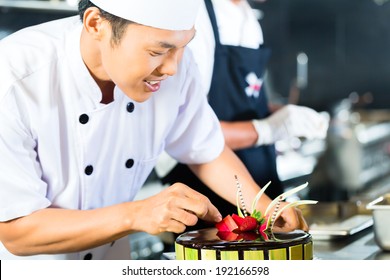 Close Up Of Young Chef Decorating Cake