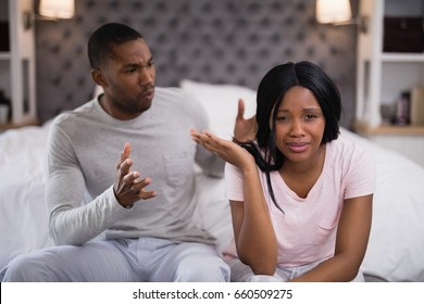 Close up of young couple arguing while sitting at home