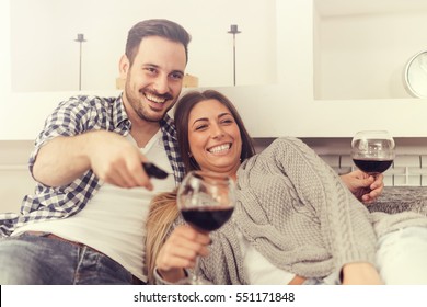 Close Up Of A Young Couple Enjoying Wine At Home