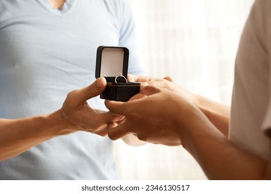 close up young couple showing engagement ring for a marriage proposal