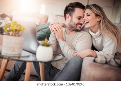 Close Up Of Young Couple Working On Laptop At Home.