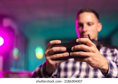 Close Up Of Young Cyber Sport Gamer Play Mobile Game By Smartphone On ESport Tournament
