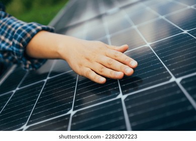 Close up of an young engineer hand is checking an operation of sun and cleanliness of photovoltaic solar panels on a sunset. Concept:renewable energy, technology, electricity, service, green, future - Shutterstock ID 2282007223