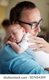 Close Up Of Young Father Holding His Newborn Baby Son