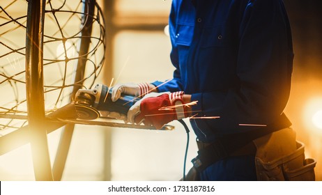 Close Up of Young Female Fabricator in Blue Jumpsuit. She is Grinding a Metal Tube Sculpture with an Angle Grinder in a Studio Workshop. Empowering Woman Makes Modern Abstract Metal Artwork. - Shutterstock ID 1731187816