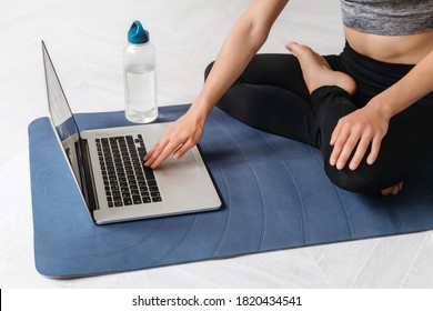 Close Up Young Fit Sporty Woman Wears Sportswear Search Online Fitness Workout Or Yoga Class Using Laptop At Home. Online Fitness Classes, Video Tutorial, Virtual Coach, Wellness Concept