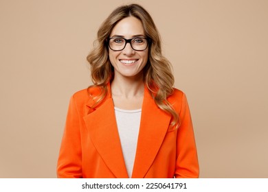 Close up young fun happy successful employee business woman corporate lawyer 30s wearing classic formal orange suit glasses work in office look camera isolated on plain beige color background studio - Shutterstock ID 2250641791
