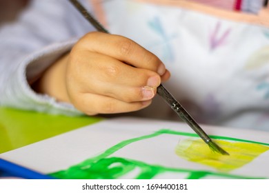 Close Up Of Young Girl Hands, With Syndactyly, Painting With Brush. Medical Condition, Webbed Fingers